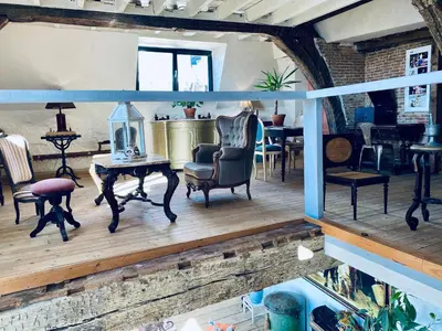 a living room with chairs and a table at The Lofty Mystic's Lodge in Antwerp