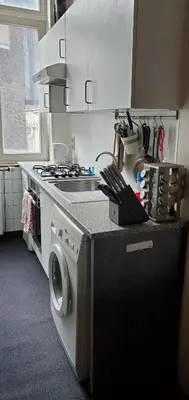 a kitchen with a stove and a washing machine at Historic Brussels in Brussels