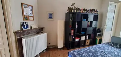 a bedroom with a black book shelf and a bed at Historic Brussels in Brussels