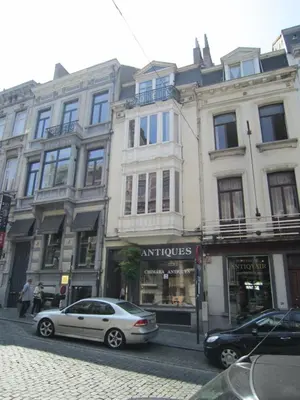 a white car parked in front of a building at Historic Brussels in Brussels