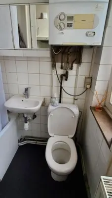 a small bathroom with a toilet and a sink at Historic Brussels in Brussels