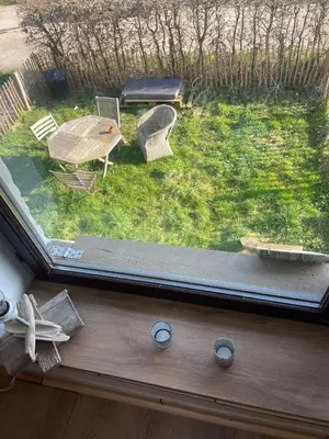a view of a backyard with a table and chairs at Petit duplex cosy coup de coeur, dans ferme de charme du 18 è siècle au milieu des champs in Bossut-Gottechain
