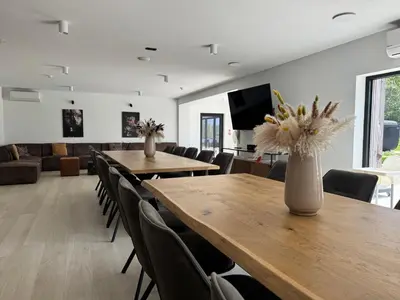 a conference room with tables and chairs and a television at Vakantiewoning The View in Gooik