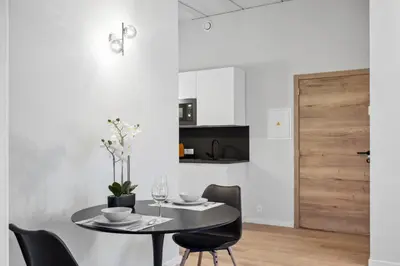 a dining room with a black table and chairs at Imperiashortstay in Zaventem