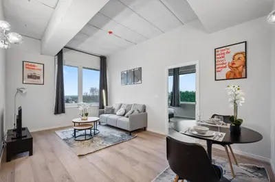 a living room with a table and a couch at Imperiashortstay in Zaventem