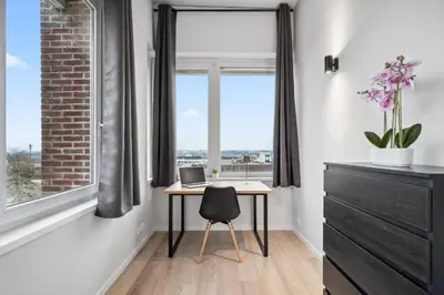 a room with a desk and a window with a laptop at Imperiashortstay in Zaventem