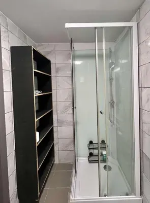 a bathroom with a shower and a glass shower stall at Brussels center city appartement in Brussels