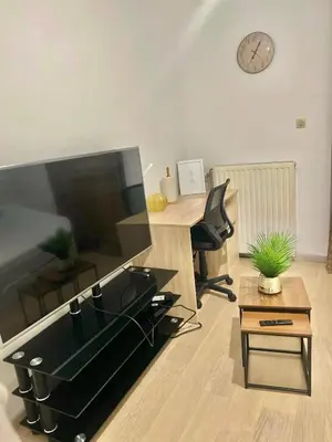an office with a desk and a chair and a clock at Brussels center city appartement in Brussels