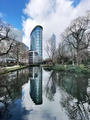 a reflection of a building in a body of water at Brussels center city appartement in Brussels
