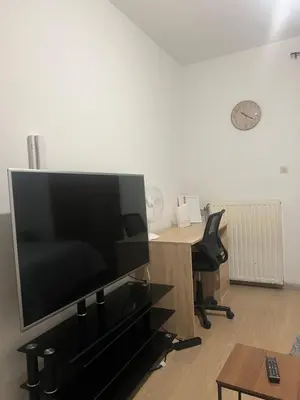 an office with a desk with a large flat screen tv at Brussels center city appartement in Brussels