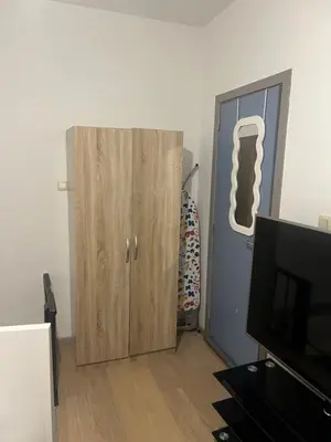 a room with a wooden cabinet and a door at Brussels center city appartement in Brussels