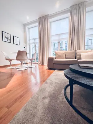 a living room with a couch and a table at Superbe appartement au coeur du Sablon in Brussels