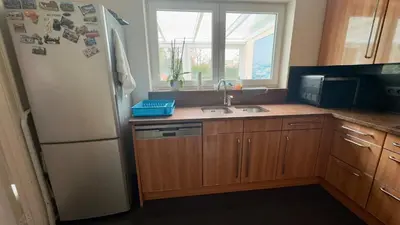 a kitchen with a refrigerator and a sink and a window at House with 5 bedrooms near Brussels in Wemmel