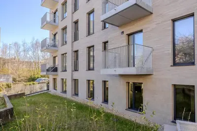 an apartment building with balconies and a yard at Stay at Brussels in Brussels