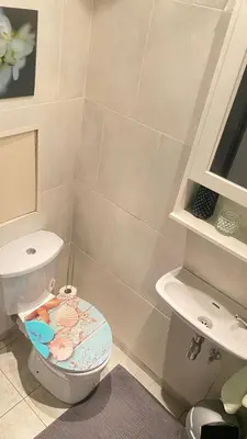 a bathroom with a toilet and a sink at Strelitzyahouse in Brussels