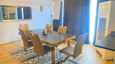 a dining room with a table and chairs at Strelitzyahouse in Brussels