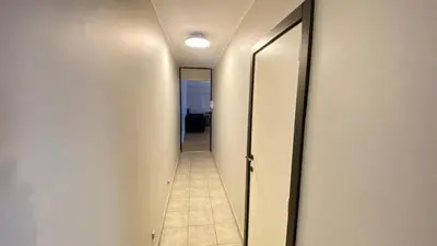 a hallway with a mirror and a tile floor at Strelitzyahouse in Brussels