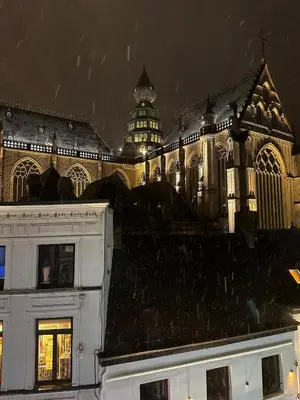 a large building with a clock tower in the background at Cozy Central Apartment with Cathedral View on the 3rd floor in Antwerp