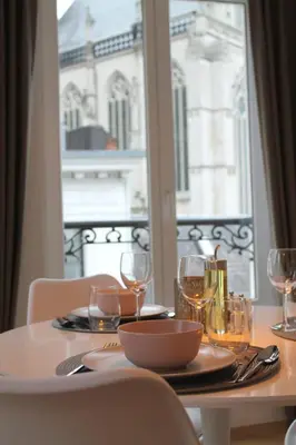 a table with wine glasses and a bowl on it at Cozy Central Apartment with Cathedral View on the 3rd floor in Antwerp