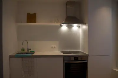 a kitchen with a sink and a stove top oven at Cozy Central Apartment with Cathedral View on the 3rd floor in Antwerp
