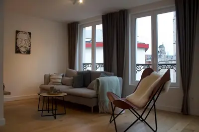 a living room with a couch and a window at Cozy Central Apartment with Cathedral View on the 3rd floor in Antwerp