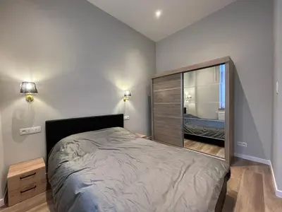 a bedroom with a bed and a large mirror at Midi Station 2 in Brussels