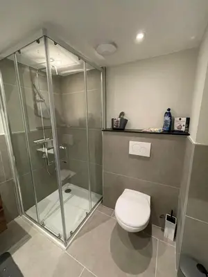 a bathroom with a glass shower and a toilet at Midi Station 2 in Brussels