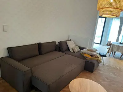 a living room with a brown couch and a table at Completely renovated apartment in Antwerp