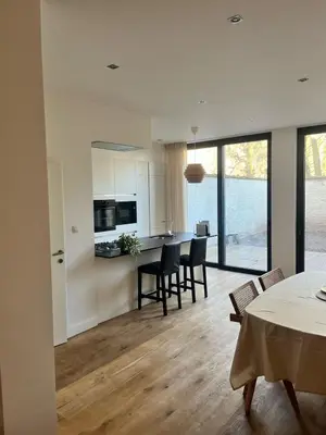a kitchen and dining room with a table and chairs at Completely renovated apartment in Antwerp