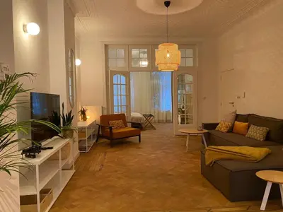 a living room with two couches and a tv at Completely renovated apartment in Antwerp