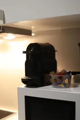 a coffee maker and a bowl of fruit on a counter at Cozy Apartment in Antwerp central in Antwerp
