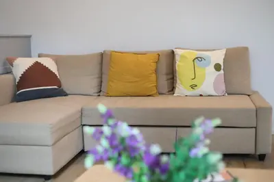 a couch with pillows on it in a living room at Cozy Apartment in Antwerp central in Antwerp