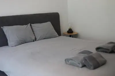 a white bed with two towels on top of it at Cozy Apartment in Antwerp central in Antwerp