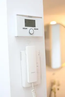 a phone hanging on a wall in a room at Cozy Apartment in Antwerp central in Antwerp