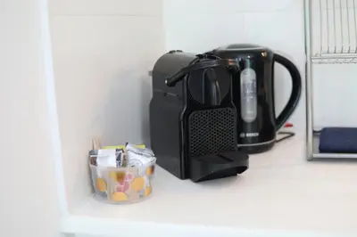 a coffee maker sitting on a shelf next to a cup at Cozy Apartment in Antwerp central in Antwerp