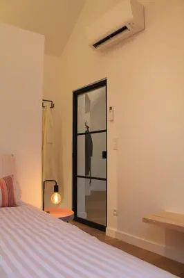 a bedroom with a bed and a sliding glass door at Charming Apartment with Cathedral View! On the 4th floor in Antwerp