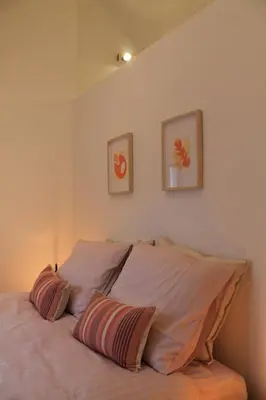 a bedroom with a bed with two pillows on it at Charming Apartment with Cathedral View! On the 4th floor in Antwerp