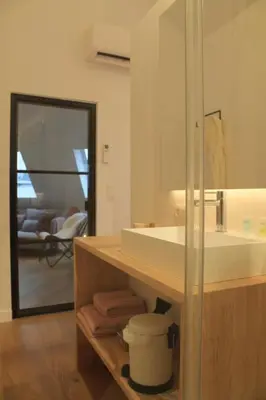 a bathroom with a white sink and a mirror at Charming Apartment with Cathedral View! On the 4th floor in Antwerp