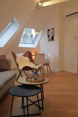 a living room with chairs and a table at Charming Apartment with Cathedral View! On the 4th floor in Antwerp