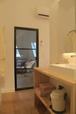 a bathroom with a sink and a mirror at Charming Apartment with Cathedral View! On the 4th floor in Antwerp