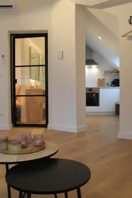 a living room with a table and a kitchen at Charming Apartment with Cathedral View! On the 4th floor in Antwerp