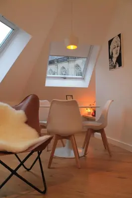 a room with two chairs and a table and a window at Charming Apartment with Cathedral View! On the 4th floor in Antwerp