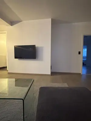 a living room with a flat screen tv on a wall at Stylish, modern & spacious apartment in Brussels in Brussels