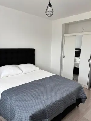 a bedroom with a large bed with a black headboard at Stylish, modern & spacious apartment in Brussels in Brussels