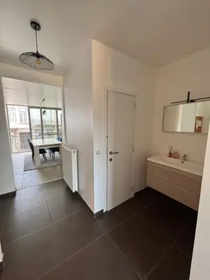 a room with a kitchen and a dining room at Stylish, modern & spacious apartment in Brussels in Brussels