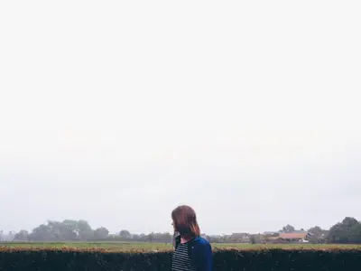 a woman standing in front of a field at Holiday home Zelenachten in Zele
