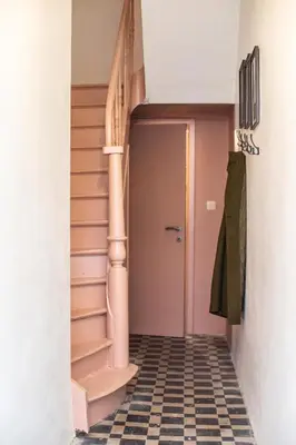 a hallway with stairs and a tile floor at Chic 3BR Apartment near Antwerpen-Centraal Station in Antwerp