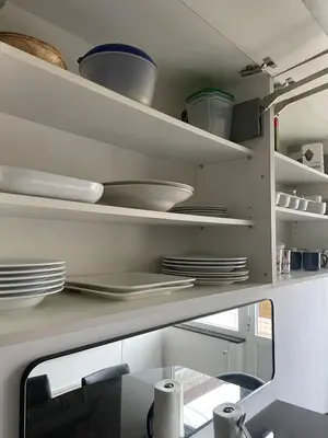 a kitchen with plates and dishes on shelves at JV House in Zellik