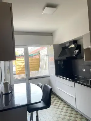 a kitchen with a table and chairs in a room at JV House in Zellik