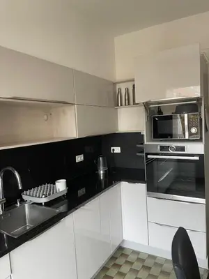 a white kitchen with a sink and a microwave at JV House in Zellik